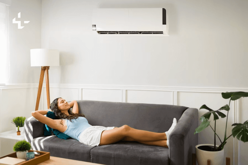 Woman relaxing on a sofa beneath a ductless mini-split — comfortable, efficient home cooling by ChillTech